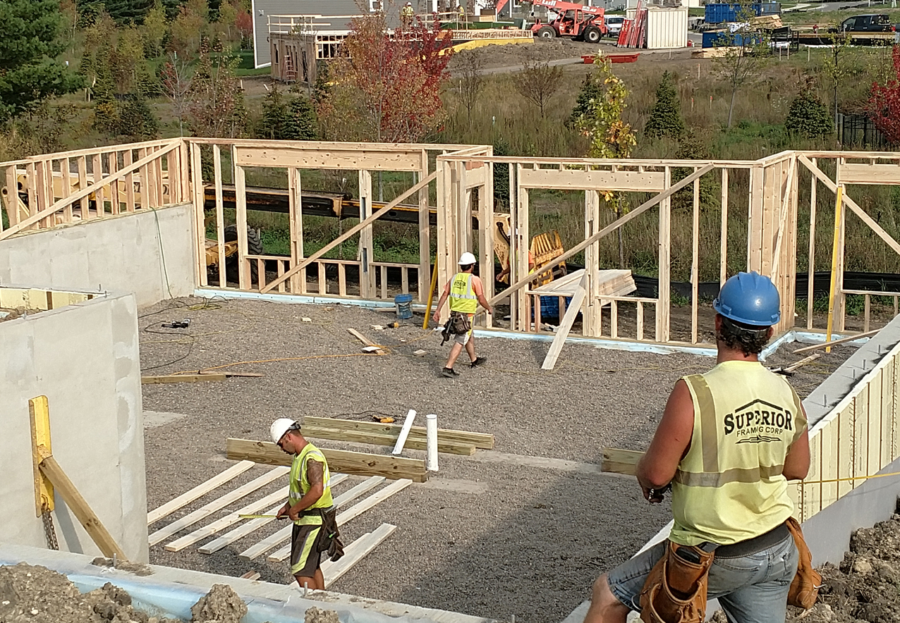Team building the beginning frame of a new home